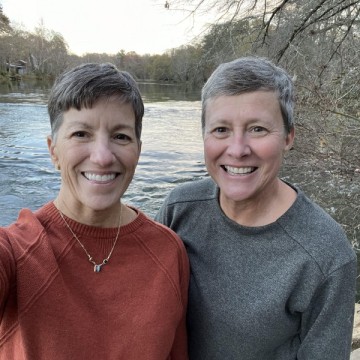 Catherine McLean with her partner, Debbie Mosure, by a lake. 
